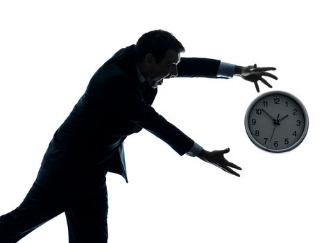 one caucasian businessman running after time  in silhouette studio isolated on white background
