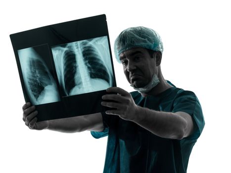 one caucasian man doctor surgeon radiologist medical examining lung torso  x-ray image silhouette isolated on white background