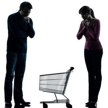 one caucasian couple woman man sad with empty shopping with shopping cart  in silhouette studio isolated on white background