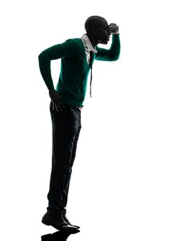one african  black man standing tiptoe looking away   in silhouette studio on white background
