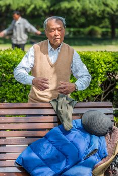 Shanghai, China - April 7, 2013: one man exercising meditation  in fuxing park at the city of Shanghai in China on april 7th, 2013