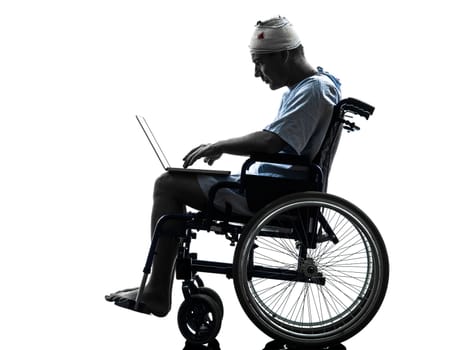 one  injured man in wheelchair  in silhouette studio  on white background