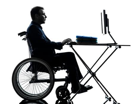 one handicapped business man computing laptop computer in silhouette studio  on white background
