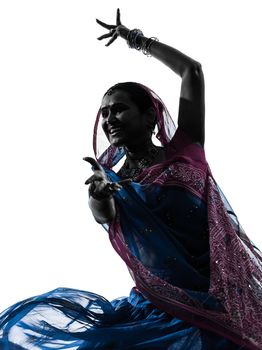 one indian woman dancer dancing in silhouette studio isolated on white background