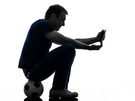 one caucasian man holding digital tablet   in silhouette on white background