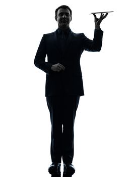 one caucasian business man holding digital tablet   in silhouette on white background