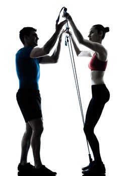 personal trainer man coach and woman exercising gymstick silhouette  studio isolated on white background