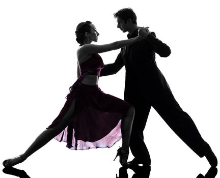 one caucasian couple man woman ballroom dancers tangoing  in silhouette studio isolated on white background