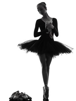 one caucasian young woman ballerina ballet dancer dancing with tutu in silhouette studio on white background