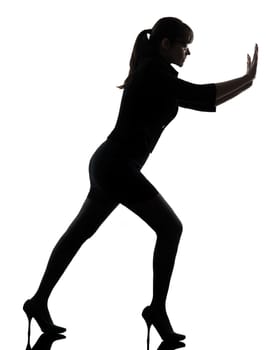 one business woman pushing  silhouette studio isolated on white background