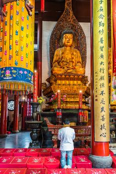 Shanghai, China - April 7, 2013: man praying at the city of Shanghai in China on april 7th, 2013