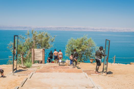 Dead Sea, Jordan - May 6, 2013 people applying dead sea mud body care treatment  on May 6 2013 , in Dead Sea Jordan