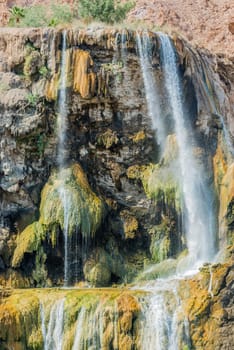 one woman bathing at ma'in hot springs waterfall  in jordan middle east