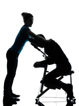 one man and woman performing chair massage in silhouette studio on white background