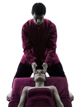woman receiving head massage in silhouette studio on white background