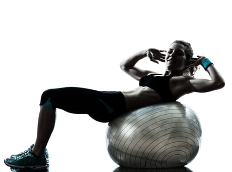 one caucasian woman exercising fitness ball workout posture in silhouette studio isolated on white background