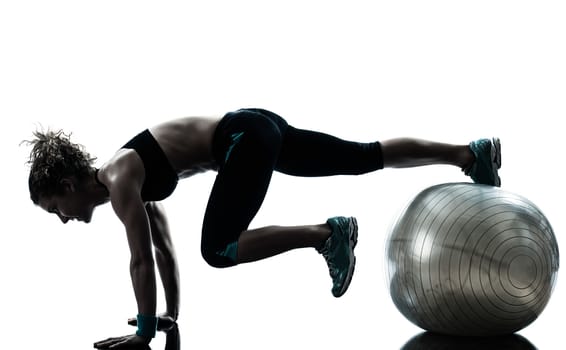one caucasian woman exercising fitness ball workout posture in silhouette studio isolated on white background
