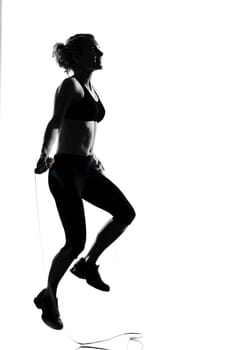 woman workout fitness posture body building jumping rope exercise exercising on studio isolated white background