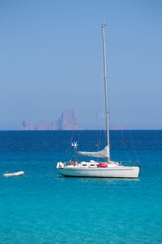 Es Vedra Ibiza background with sailboat from Formentera in Balearic Islands