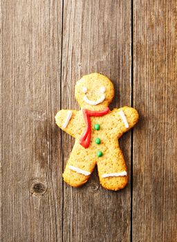 Christmas homemade gingerbread man over wooden table