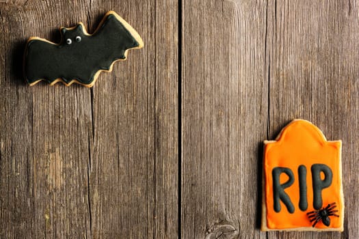 Halloween homemade gingerbread cookies over wooden table