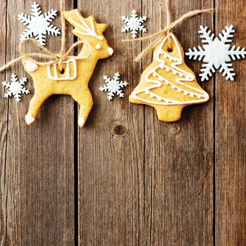 Christmas homemade gingerbread cookies over wooden table