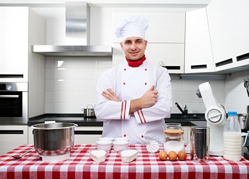 Male chef at kitchen getting ready to cook