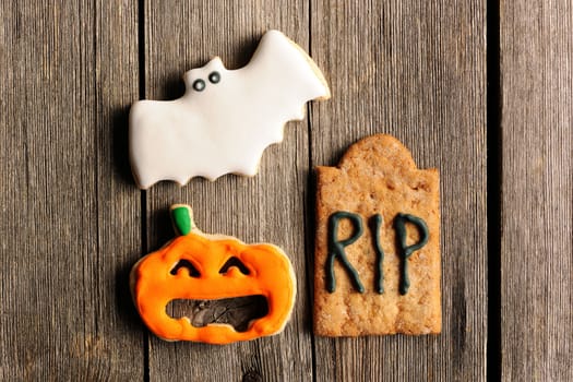 Halloween homemade gingerbread cookies over wooden table