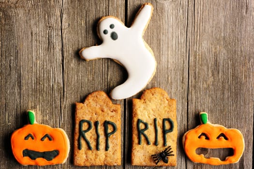 Halloween homemade gingerbread cookies over wooden table