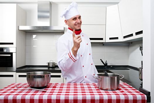 Male chef at kitchen getting ready to cook