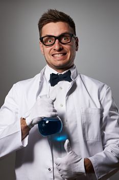 Crazy scientist against grey background