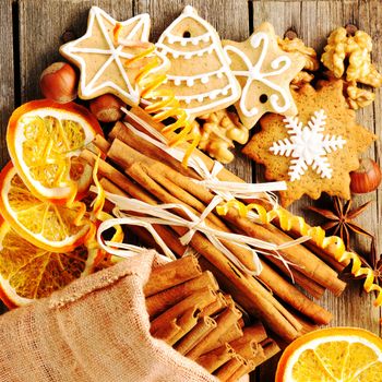 Christmas homemade gingerbread cookie and spices over wooden table