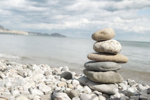 A tall pile of rocks stacked on the beach