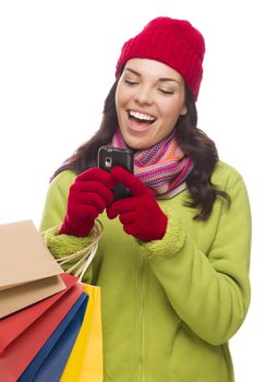 Mixed Race Woman Wearing Winter Clothing Holding Shopping Bags Texting On Cell Phone Isolated on White Background.