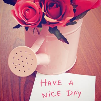 Message "have a nice day" with roses in watering can 