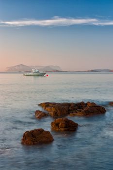 Yachts at sunrise on the Romazzino beach on Sardinia