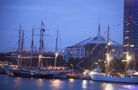 RIGA, LATVIA - JULY 25: Illuminated The tall ships races ships in port July 25, 2013 Riga, Latvia. The race are held annually with purpose to encourage international friendship and training for young people in the art of sailing. ships in port July 25, 2013 Riga, Latvia. The race are held annually with purpose to encourage international friendship and training for young people in the art of sailing.