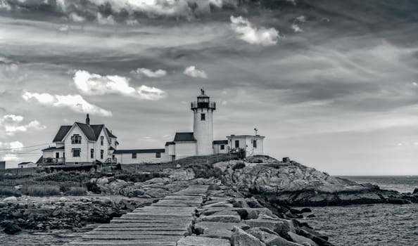 The lighthouse and the living quarters are shown in this image from Gloucester, MA.