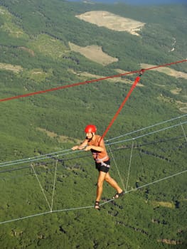 Man walking on a rope at Ai-Petri summit, Crimea peninsula, Ukraine