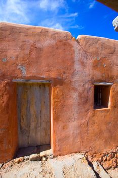 Ibiza grunge orange facade in Benirras beach at Balearic Islands Spain