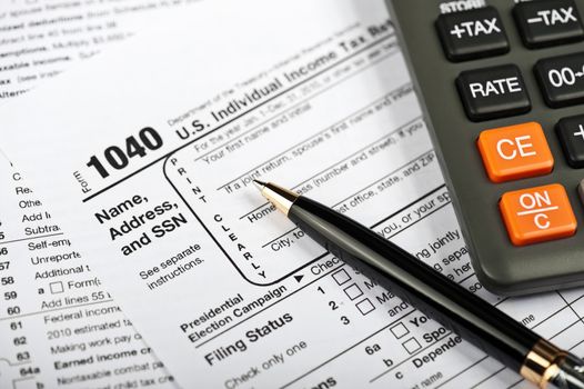 A Tax Form, Pen and Calculator.