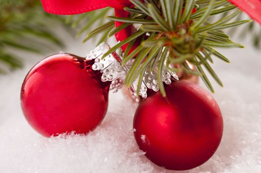 Red christmas balls in the snow