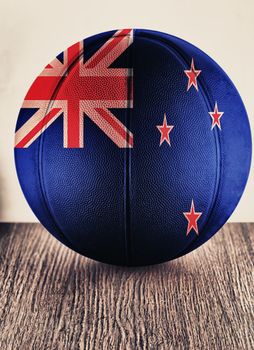Close up of an old leather basketball with New Zealand flag