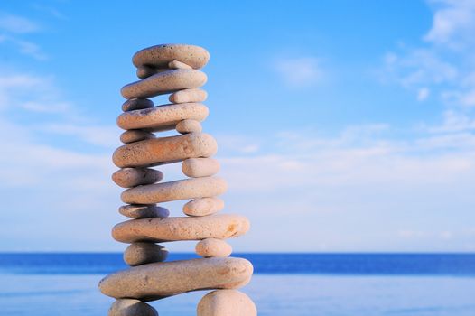 Balancing of white pebbles each other on the seacoast