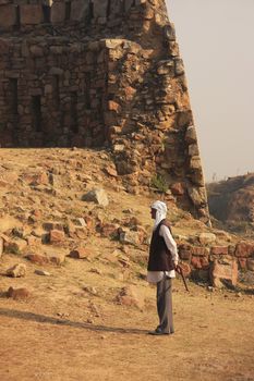 Local guard walking around Tughlaqabad Fort, New Delhi, India