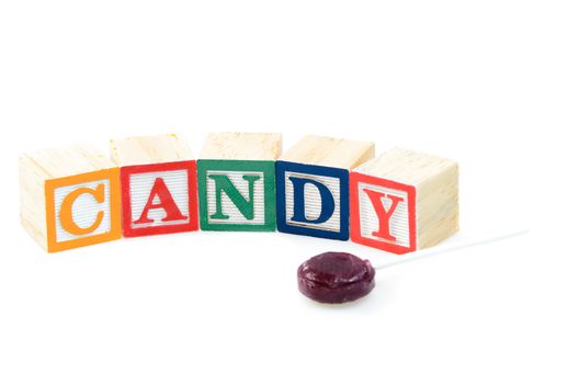 Baby blocks spelling candy. Isolated on a white background.