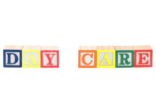 Baby blocks spelling day care. Isolated on a white background.