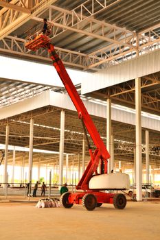 Forklift is lifting a construction worker.