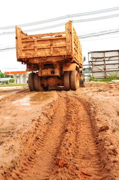 Dumpers are poured earth in construction.