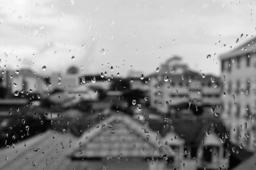 Raindrops on the glass on the night of heavy rain.